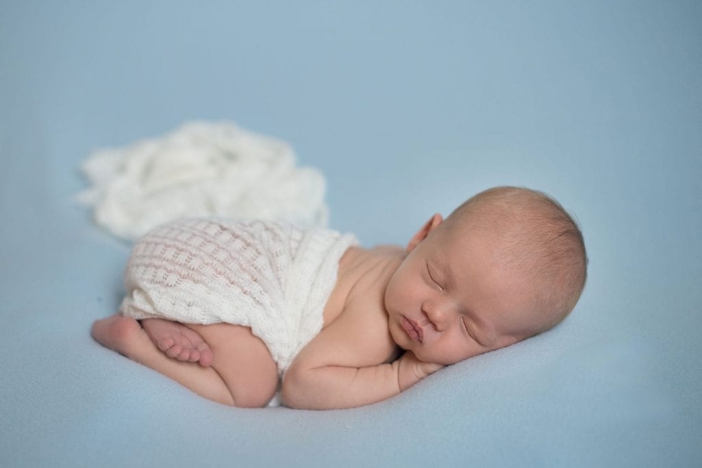new born baby with light blue background