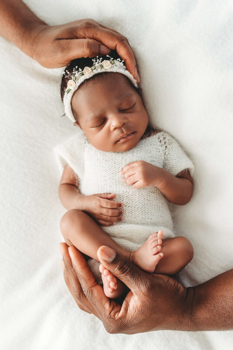 atlanta newborn photographer - newborn baby in soft white onesie with parents' hands
